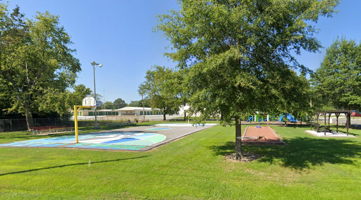 John W. Jones Park Basketball Court, corn hole, and Play set.